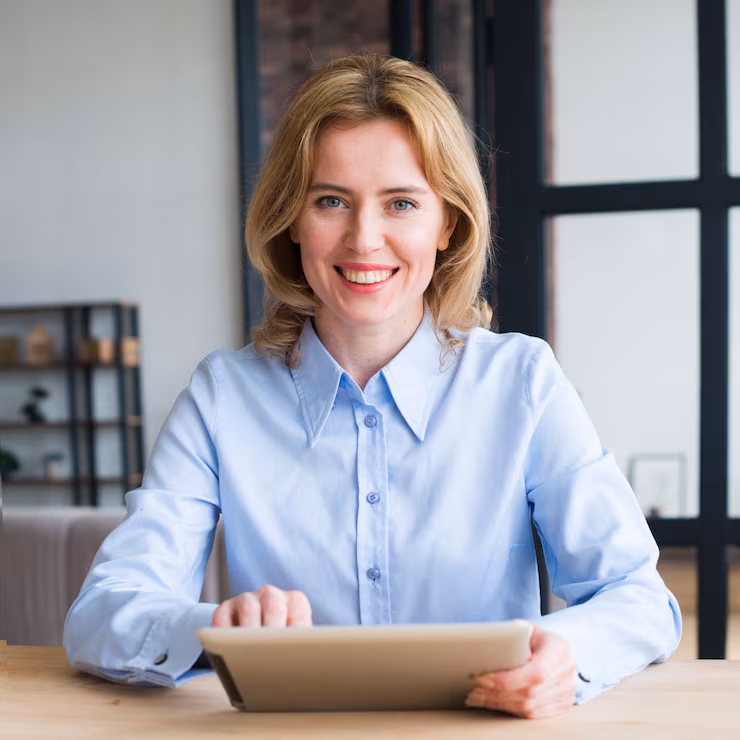 joyful-business-woman-using-tablet-table_23-2148095762