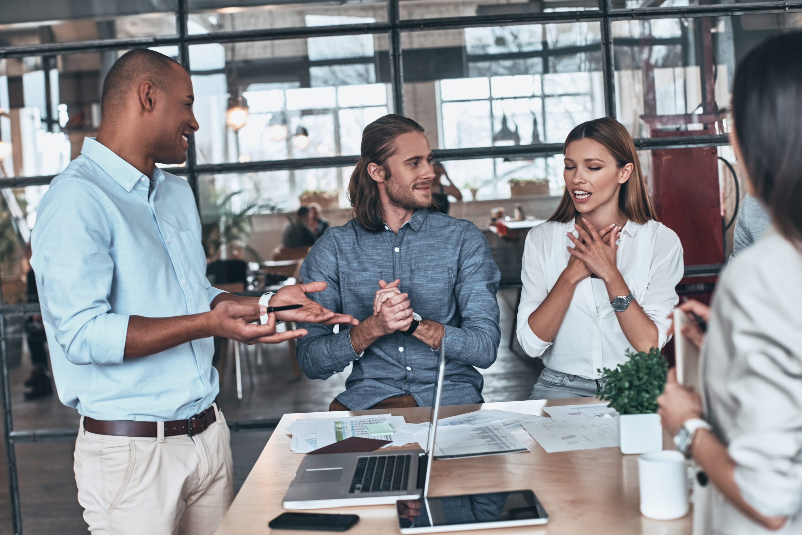 Developing new project. Group of young business people communicating while working in the office